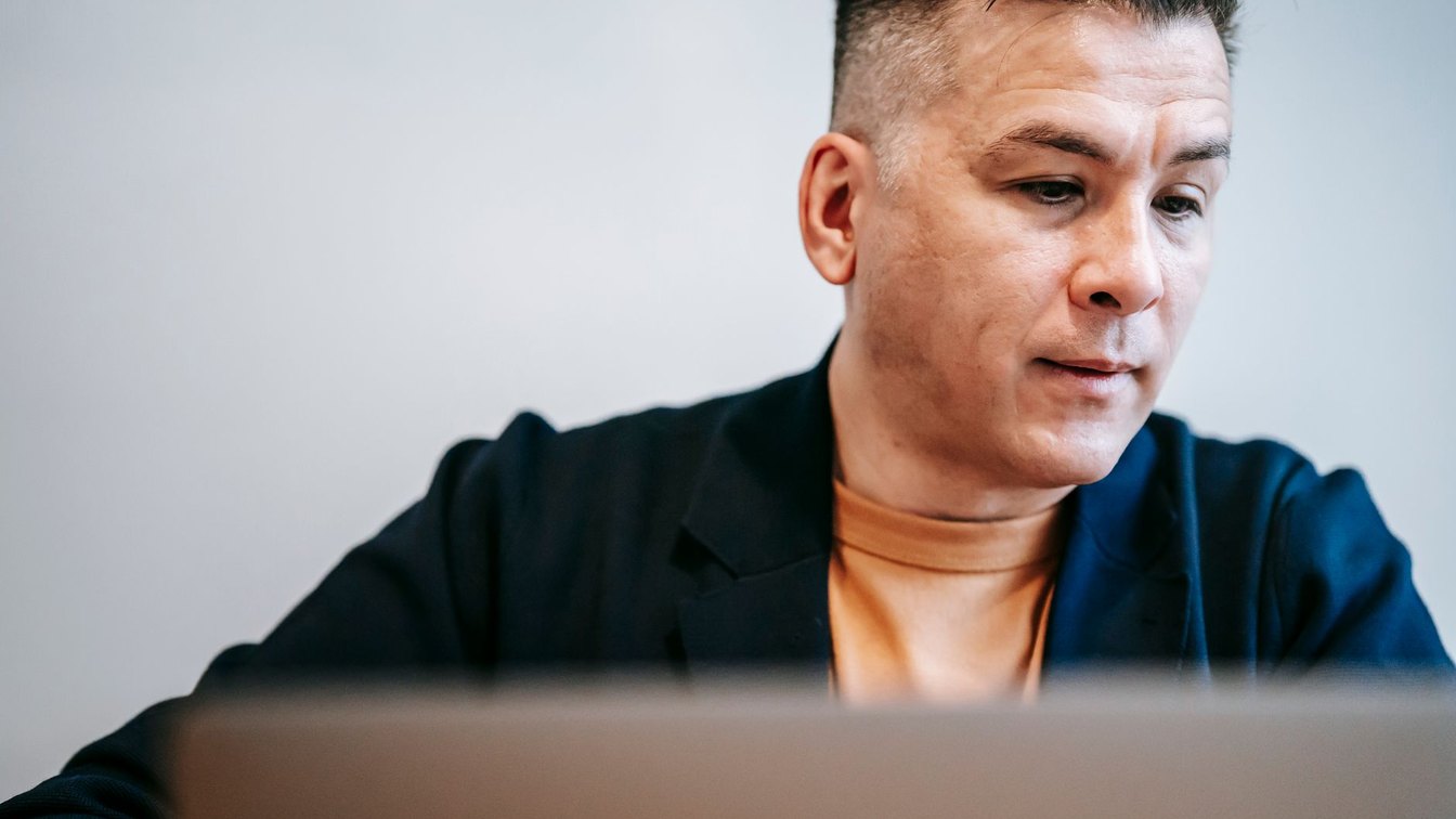 A focused man working at his laptop